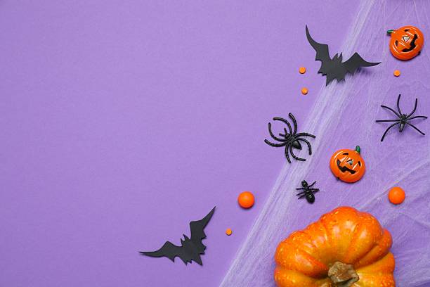 istock Halloween holiday decorations including pumpkins, spiders, bats on orange background 2254256292