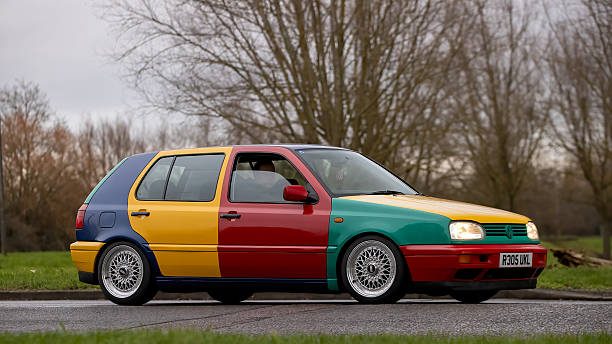 Milton Keynes,Bucks,UK - Jan 1st 2026: 1997 multi coloured Volkswagen Golf  classic car driving on a British road