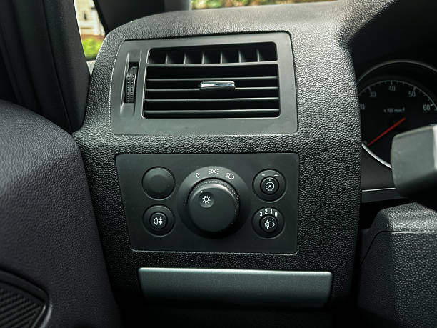 istock Close-up view of a car dashboard control panel showing various knobs and dials for adjusting air conditioning and lights, captured in a parked vehicle during daylight 2254256716