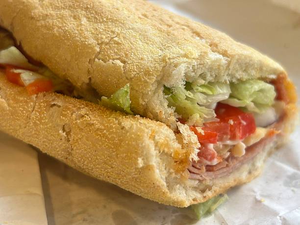 istock Crusty Baguette Sandwich With Ham, Cheese, Lettuce, And Tomato For Lunch 2254257783