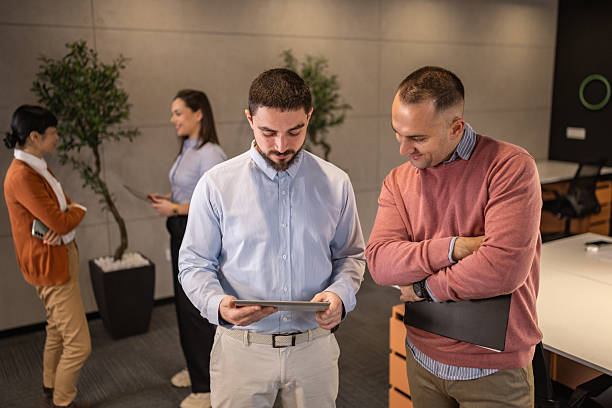 istock Professional teammates collaborating with digital tablet in contemporary office space 2254266129