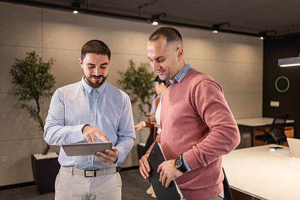 istock Two male colleagues collaborating using digital tablet and clipboard 2254268087