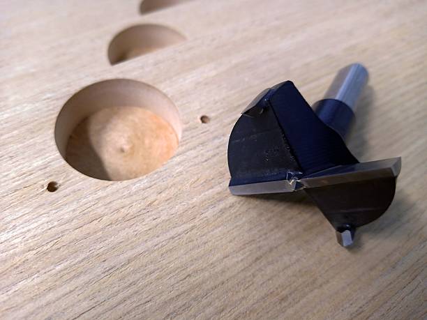 drilling holes 35mm  with a hand drill and a thin drill bit. close-up. technological process. illustration. space for text.