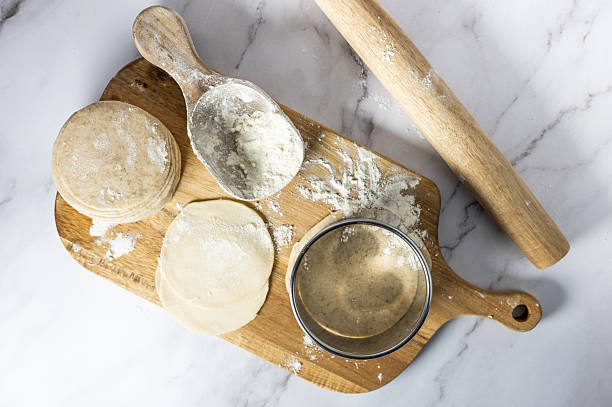 istock Dumpling dough sheets stacked with flour, ready for homemade cooking. 2254273225