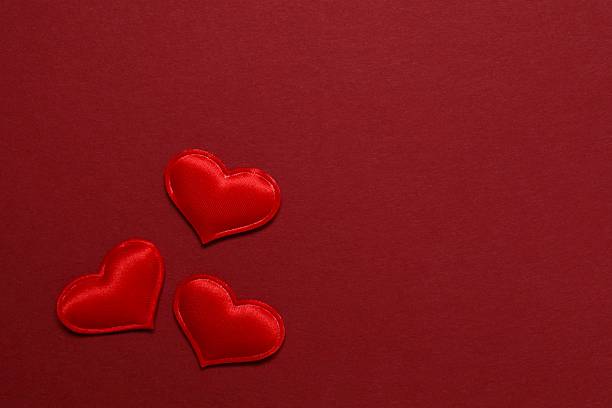 Red hearts on color background
