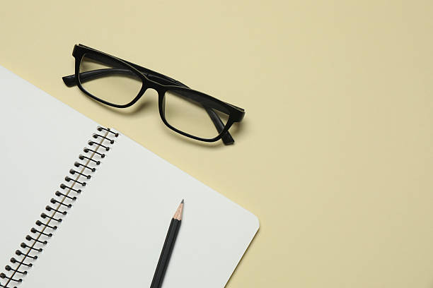 istock Flat lay with glasses, pencil and notebook on color background, top view 2254277013