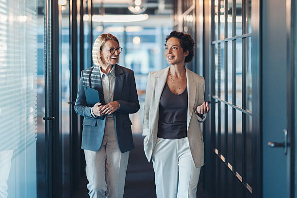 istock Two businesswomen having a conversation in the corridor 2254278370