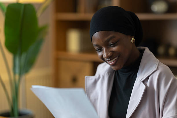 istock Young black woman reading report with happy expression 2254278717