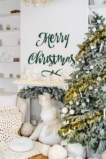 istock Festive winter hearth with frosted tree and joyful holiday sentiment 2254279117