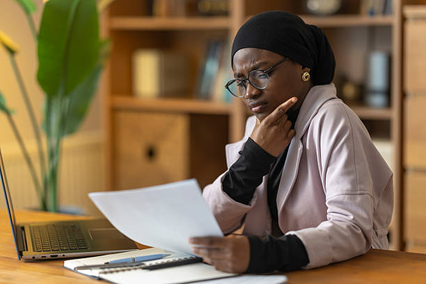 istock Muslim woman reading document, analyzing business strategy 2254279245