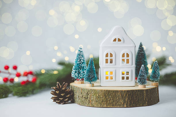 istock White house decoration with tiny evergreen trees and pine cone on wood slice, soft light bokeh 2254279717