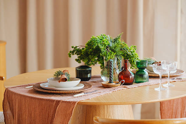 istock Elegant table setting with greenery, colored vases, and sparkling glasses for a special meal 2254279732