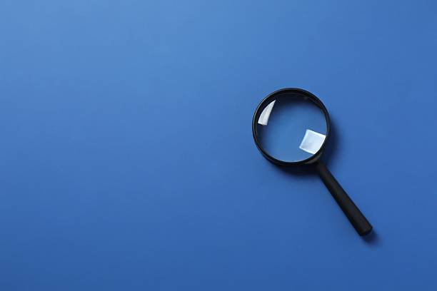 istock Magnifying glass on color background 2254280027