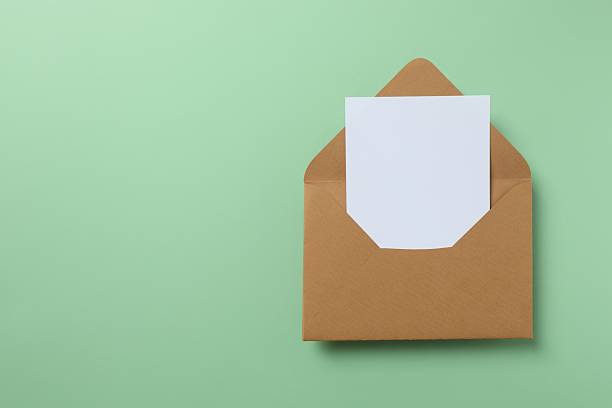 istock Paper envelope with paper card on color background 2254280651