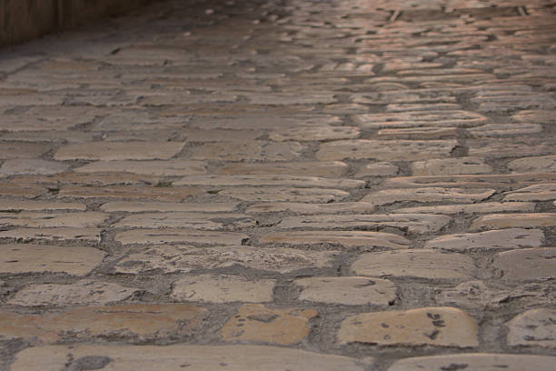 a street in the historic downtown district of Cordoba, Spain, made of paving stones of various sizes and shapes and colors
