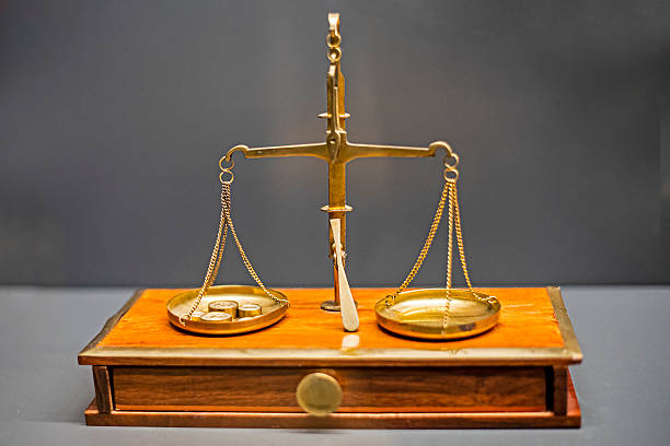 Gilded scales on a gray background. Lawyer's Day