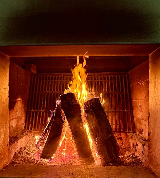 Fire pit. Last day of December  2025,  flames, woods logs ,ashes, warmth .night.