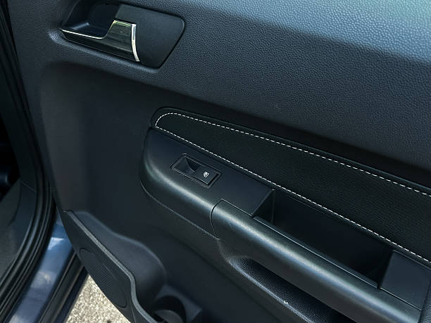 istock Door handle and window control panel inside a modern vehicle showcasing sleek design and functionality, captured in bright daylight for detailed clarity and aesthetic appeal 2254285834