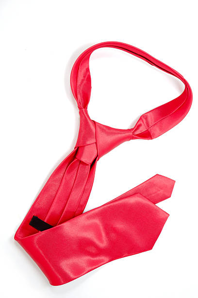 istock Vibrant red necktie laid out on white background close-up view 2254286055