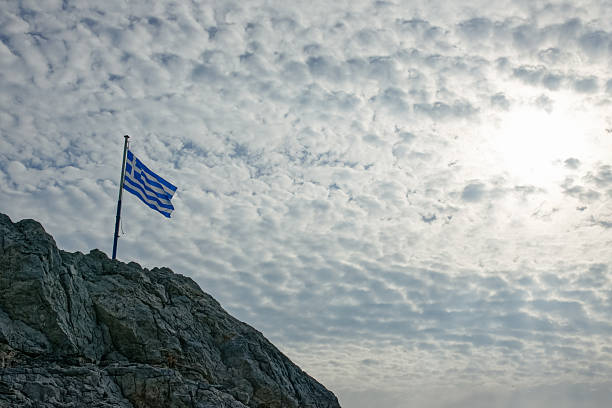 istock Greek Flag On Rocky Cliff 2254288286