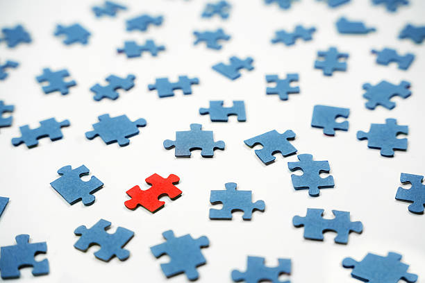 Four yellow wooden puzzle pieces labeled \