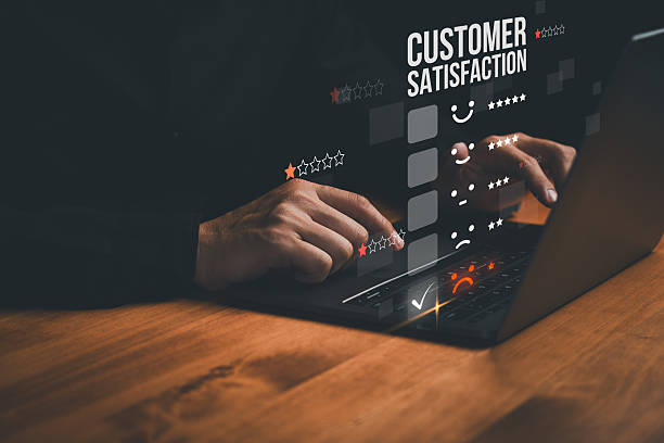 istock Close-up of hands using a laptop with a customer satisfaction survey interface, showing star ratings and emoticons, symbolizing feedback, service quality, customer service and experience. 2254293591