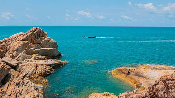 istock Large Granite Boulders Scattered in Clear Blue Tropical Ocean 2254294388