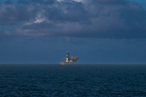 istock Offshore oil platform, drilling rig, and supply boat at twilight 2254298052