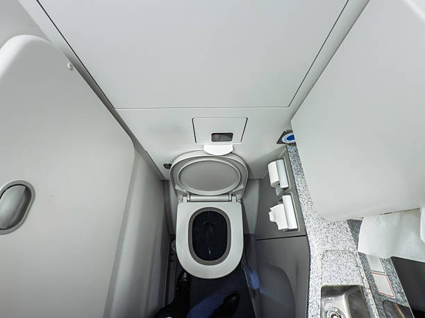 istock High-angle view of a compact lavatory inside a commercial airplane during a flight, some airplaine toilets. The small restroom features a toilet bowl, sink, and standard amenities for passengers. 2254301941