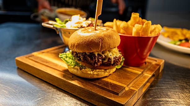 istock Large Beef Burger with Fries on Wooden Board 2254302502