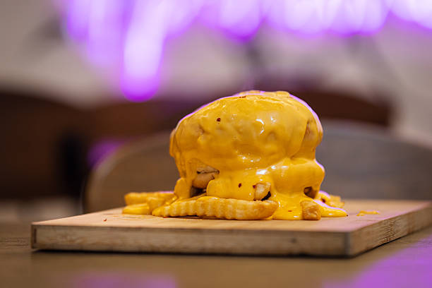 Cheddar cheese covered hamburger is serving at fast food restaurant.