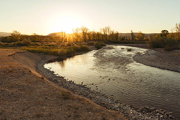 istock Calm River Flowing Through Valley Illuminated By Golden Sunset 2254311744