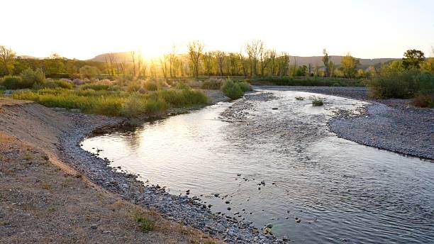 istock Calm River Flowing Through Valley Illuminated By Golden Sunset 2254311754