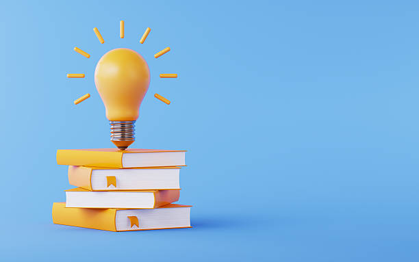 istock Yellow Light Bulb on Same Color Books Over Blue Background 2254311818