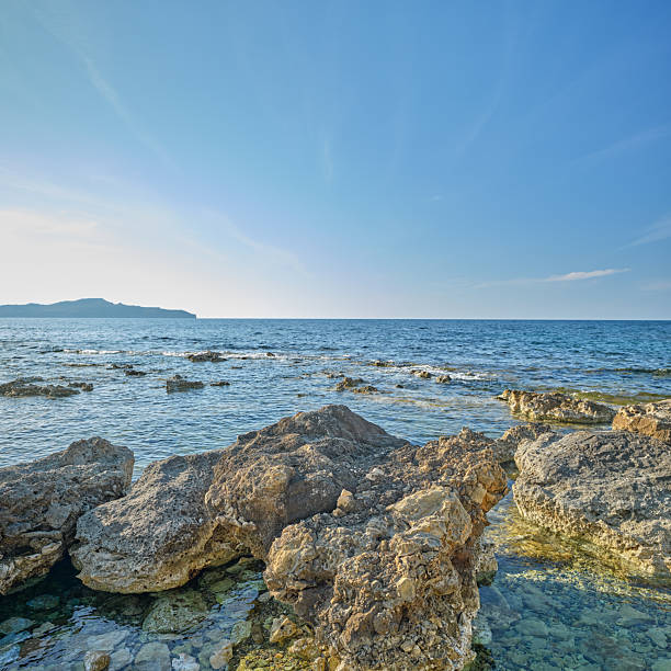 A rocky coastline with sunshine, blue sky and crystal clear water  - Crete,  Greece, Mediterranean Sea