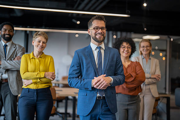 istock Confident business team smiling at the camera in modern office 2254312282
