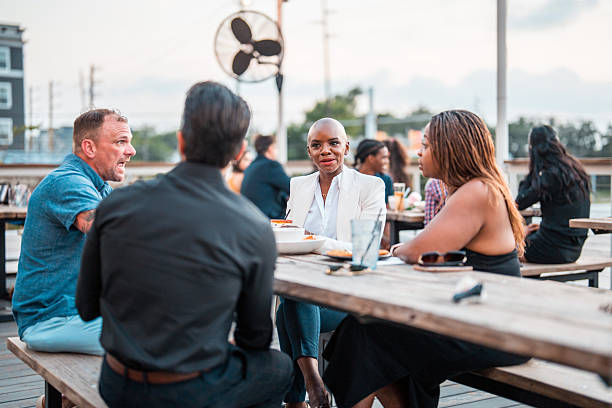 istock Diverse Friends Enjoying Dinner on Restaurant Terrace at Sunset 2254312374