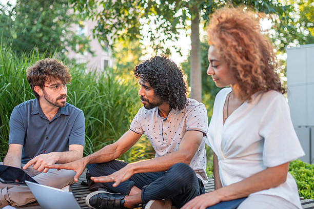 istock Diverse Executives in Outdoor Business Strategy Session 2254312413