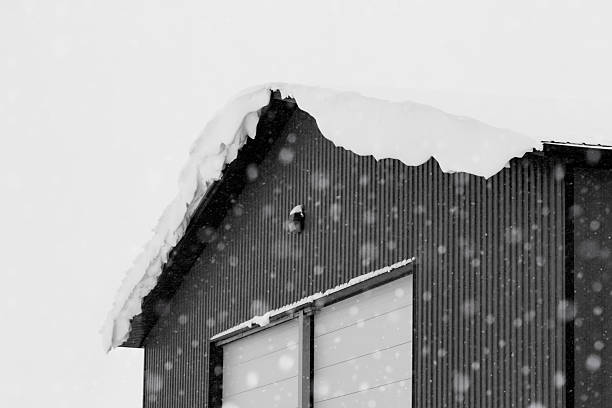 Industrial storage building covered with snow after snowfall.