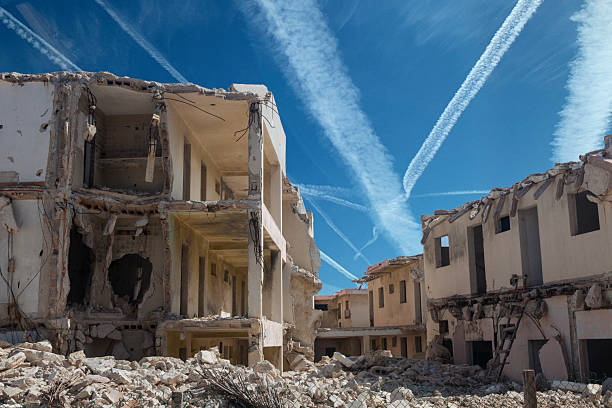 Ruined apartment buildings and vapour trails in sky, conceptual image of destruction