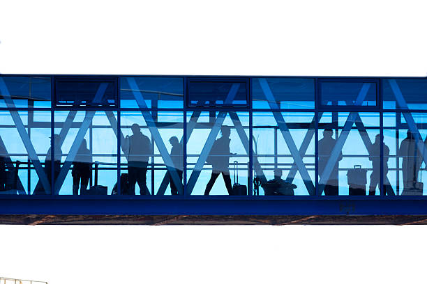 Shenzhen, China - October 25, 2019: Motion Blur of People Walking in modern corridor with glass and steel.