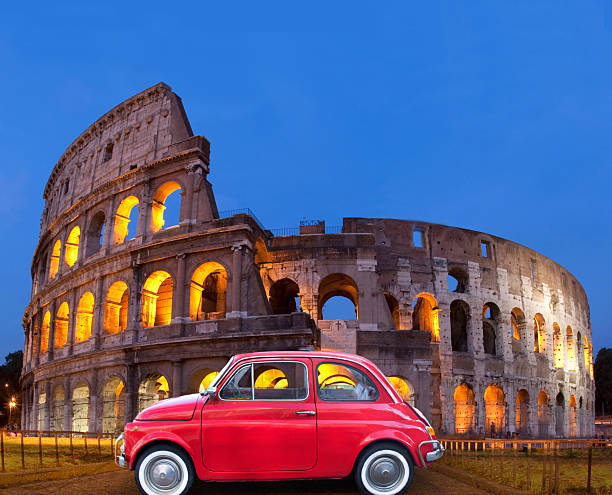 Colosseum at night with old style small car parked nearby, composite image