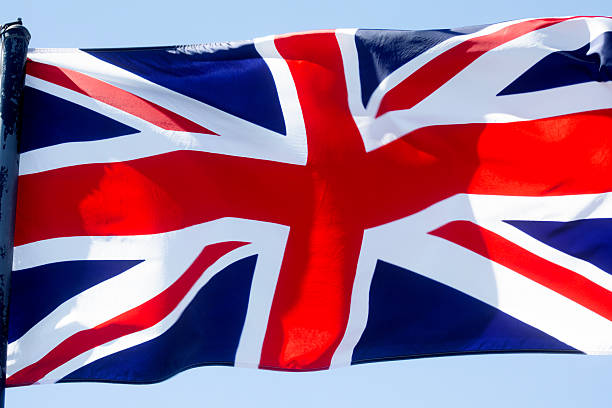 A British flag flying in the wind on a summer's day.