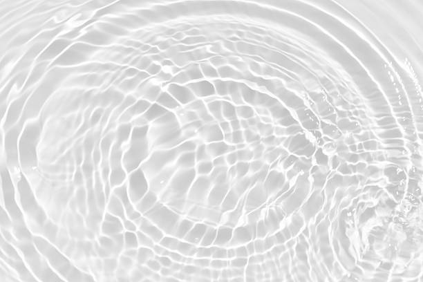 istock White water with ripples on the surface. Defocus blurred transparent white colored clear calm water surface texture with splashes and bubbles. Water waves with shining pattern texture background. 2254317165