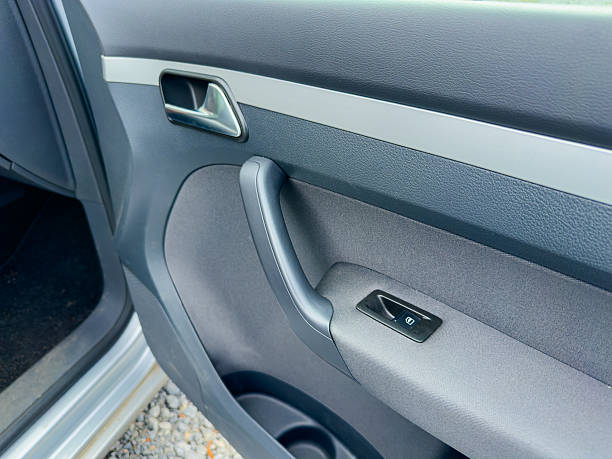istock Modern car interior showing polished door handle and sleek design elements in bright sunlight at a scenic location 2254320298
