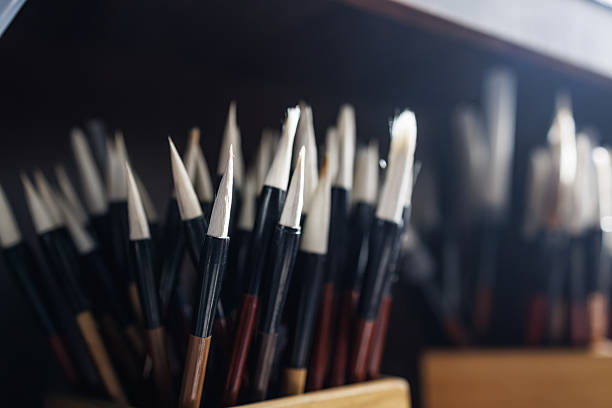 Many Chinese calligraphy brushes are packed in porcelain pen holders and placed on shelves.