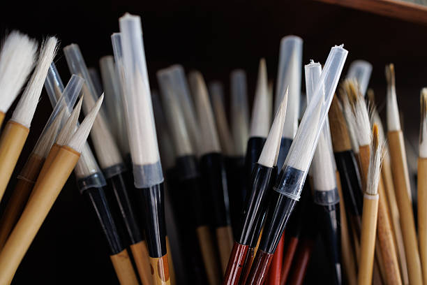 Many Chinese calligraphy brushes are packed in porcelain pen holders and placed on shelves.