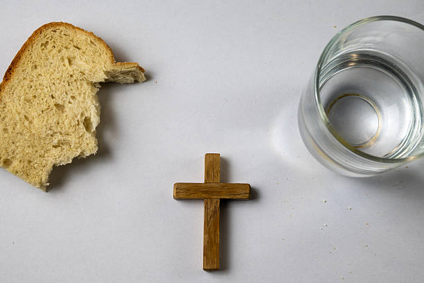 Consecrated communion hosts stored in golden ciborium on altar table, sacred element of Catholic Eucharist ceremony and Christian faith tradition.