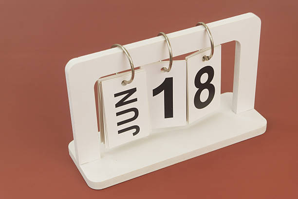 istock June 18 on calendar on brown background 2254322531
