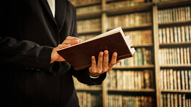 istock Professional woman reading open book inside library, information management, cataloging, knowledge organization, user guidance, literacy promotion, the expanding role of modern librarians in digital. 2254322811
